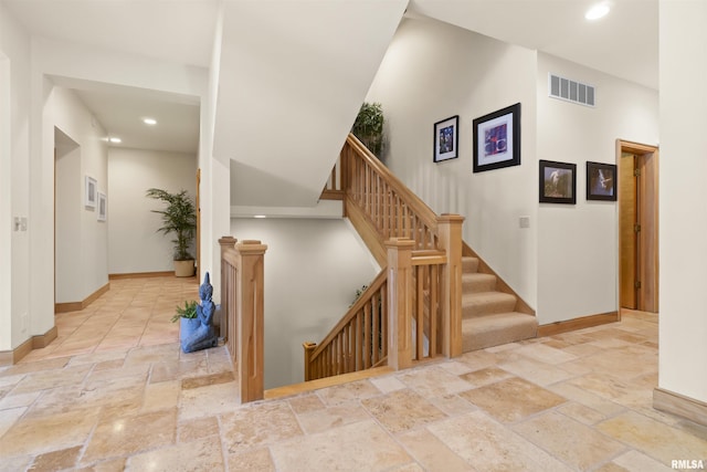 200 W Ravinwoods Rd, Peoria, IL 61615 - stairs featuring stone tile floors, baseboards, and recessed lighting