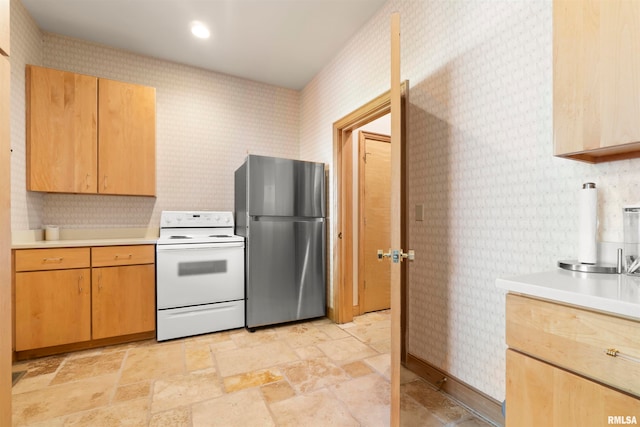 kitchen featuring stainless steel fridge and electric stove