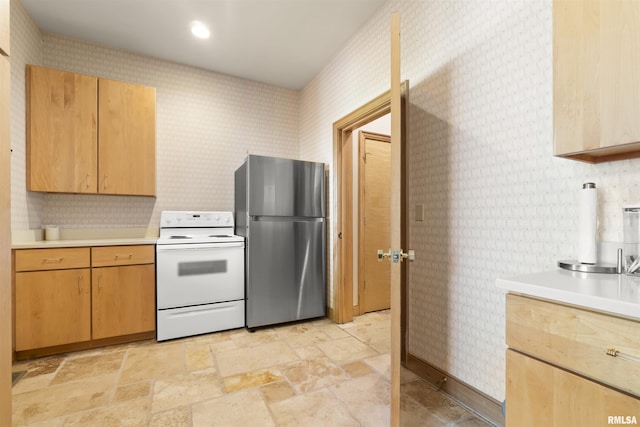 200 W Ravinwoods Rd, Peoria, IL 61615 - kitchen with freestanding refrigerator, white electric range oven, wallpapered walls, light countertops, and light stone finish flooring