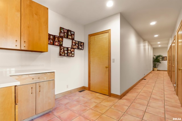 hall with light tile patterned floors