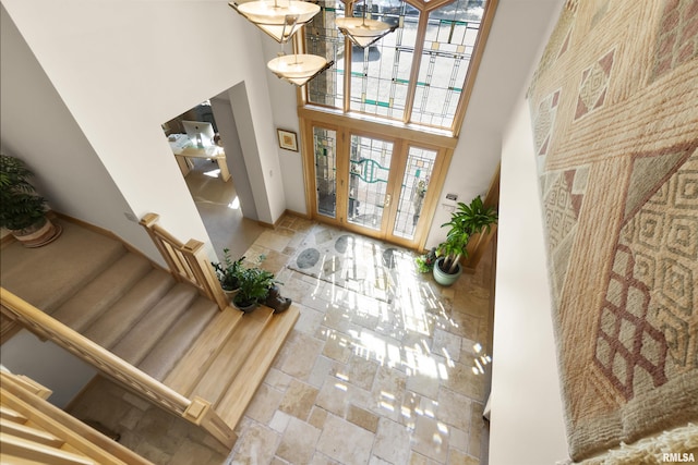 200 W Ravinwoods Rd, Peoria, IL 61615 - foyer with a high ceiling, stone tile floors, plenty of natural light, stairway, and baseboards