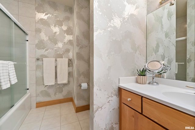 bathroom with enclosed tub / shower combo, vanity, and tile patterned floors