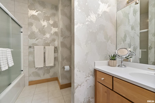 200 W Ravinwoods Rd, Peoria, IL 61615 - full bath featuring tile patterned flooring, wallpapered walls, vanity, bath / shower combo with glass door, and baseboards