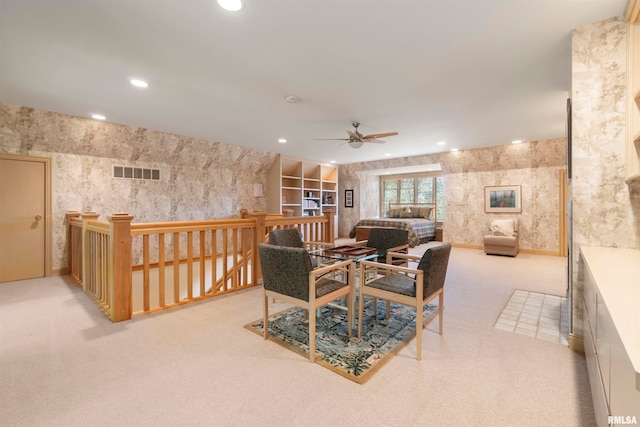 dining room featuring light carpet and ceiling fan