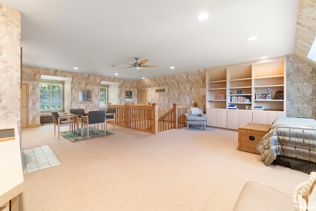 carpeted living room featuring ceiling fan