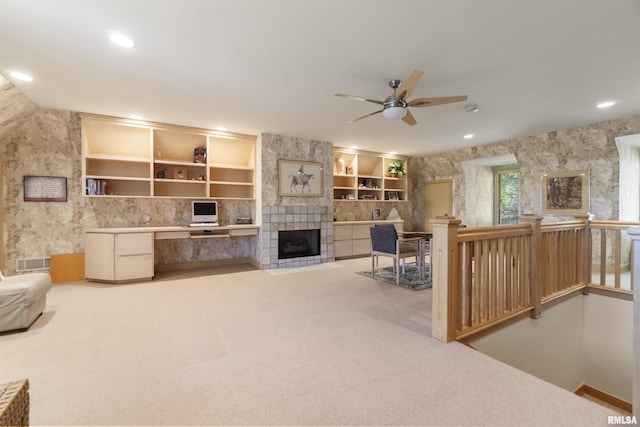 200 W Ravinwoods Rd, Peoria, IL 61615 - carpeted living room with ceiling fan, a tiled fireplace, recessed lighting, and a desk