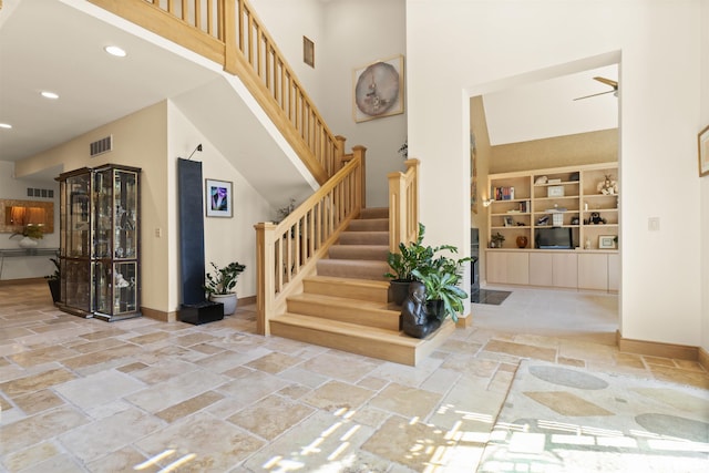 200 W Ravinwoods Rd, Peoria, IL 61615 - entryway featuring stone tile floors, a high ceiling, stairs, baseboards, and recessed lighting