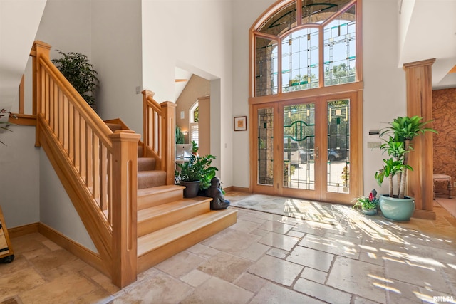 foyer featuring a towering ceiling