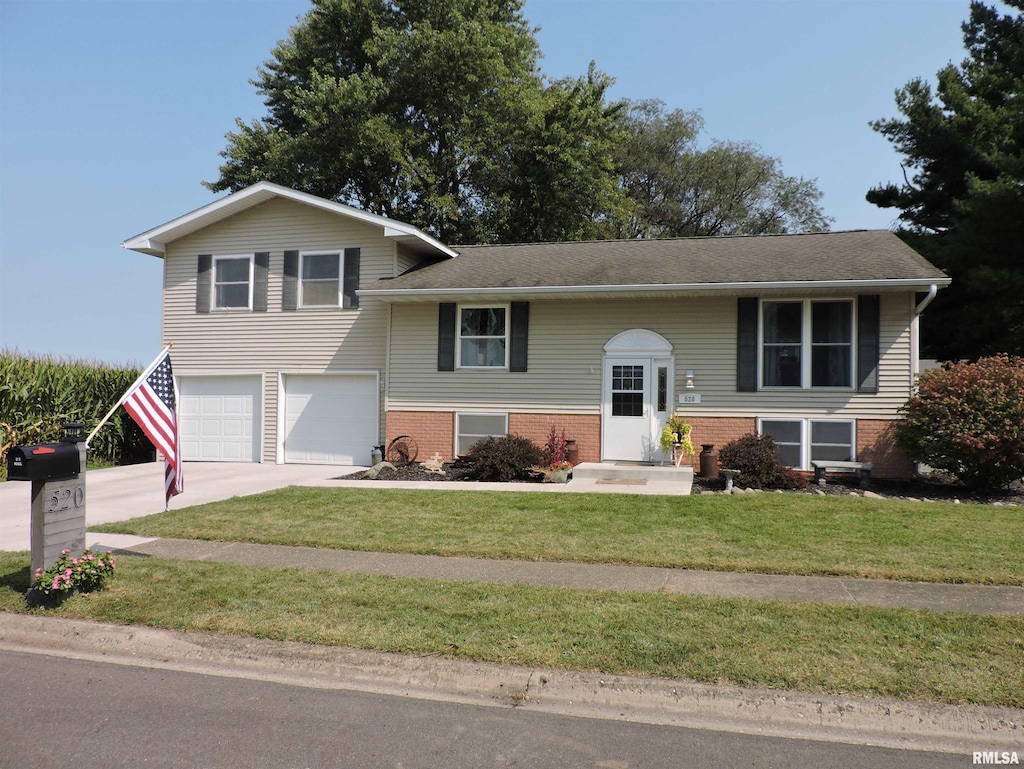 raised ranch with a garage and a front yard