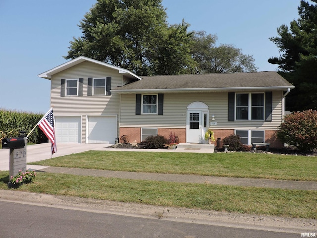 raised ranch with a garage and a front yard