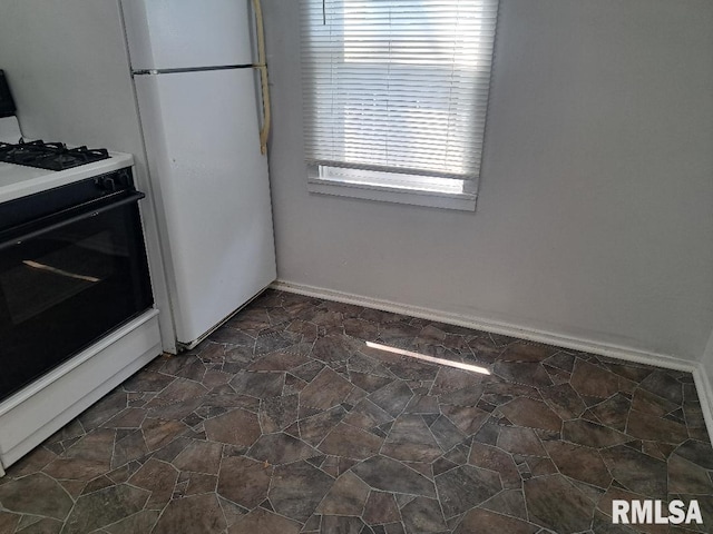 kitchen featuring a healthy amount of sunlight and white gas range oven