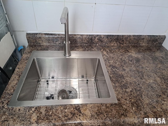 details with white cabinetry and a sink