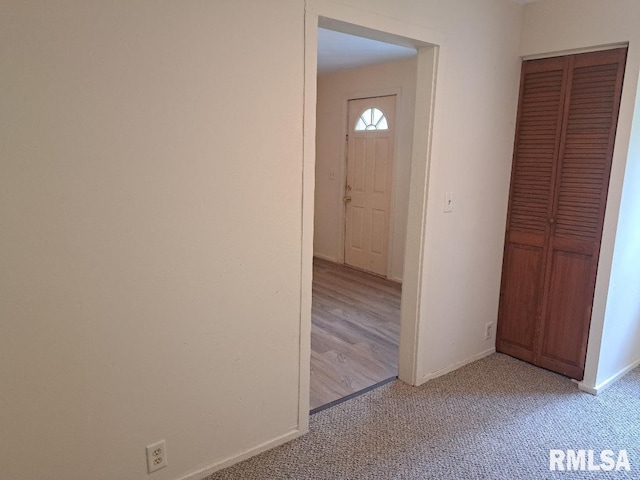 foyer with light colored carpet and baseboards