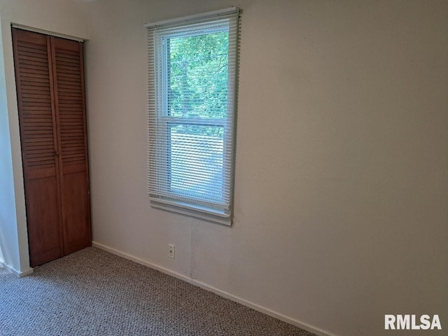 unfurnished bedroom with a closet and carpet floors