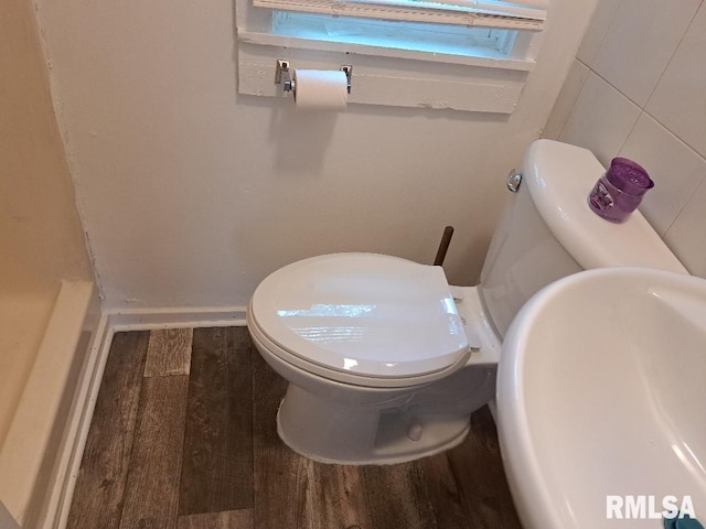 bathroom with wood finished floors, toilet, and a sink