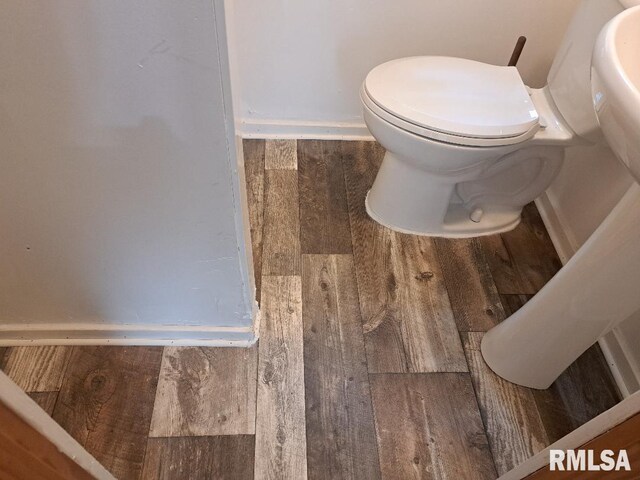 bathroom with toilet and wood-type flooring