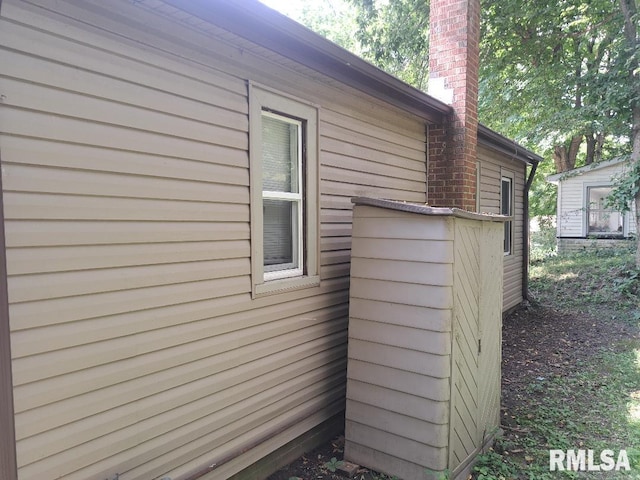 view of side of home featuring a chimney