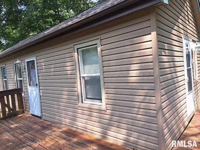 view of property exterior with a deck