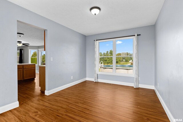 empty room with ceiling fan and wood-type flooring