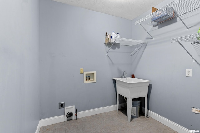 washroom featuring electric dryer hookup, hookup for a washing machine, and a textured ceiling