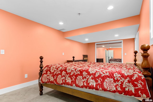 bedroom featuring a closet and concrete floors