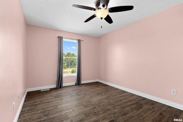 spare room with ceiling fan, dark hardwood / wood-style flooring, and a textured ceiling