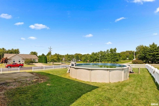 view of yard with a fenced in pool