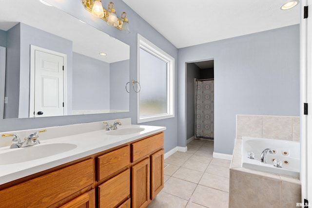 bathroom with vanity, tile patterned flooring, and a relaxing tiled tub