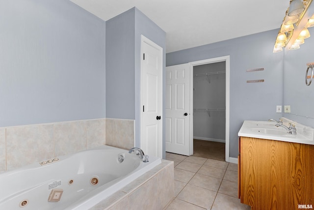 bathroom featuring tile patterned floors, tiled tub, and vanity