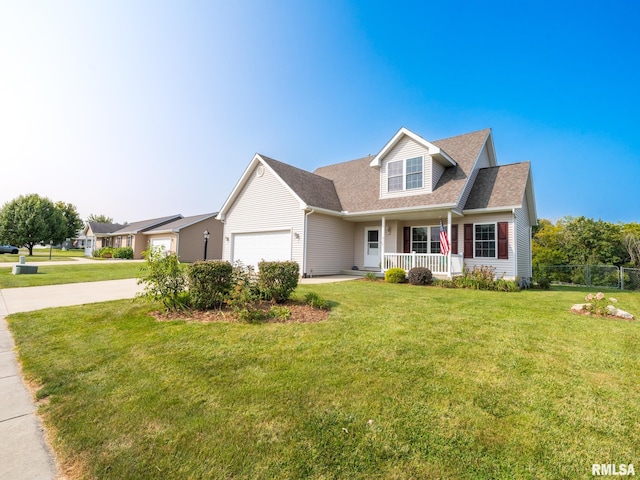 view of front of house featuring a front yard, a garage, and a porch