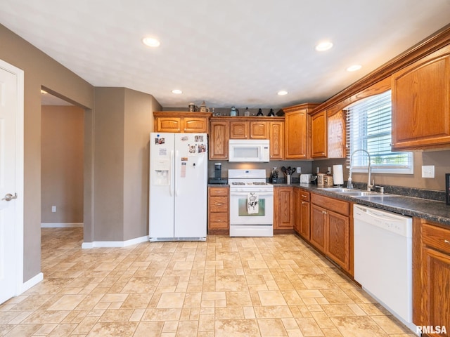 kitchen featuring white appliances and sink