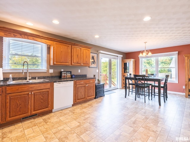 kitchen featuring dishwasher, a chandelier, a healthy amount of sunlight, and sink