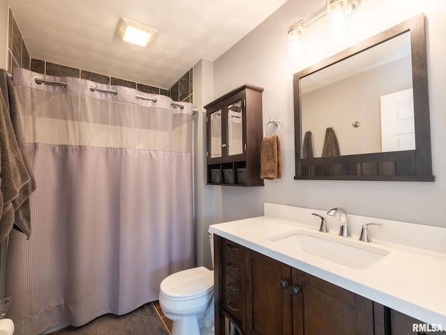 bathroom with vanity, toilet, and walk in shower