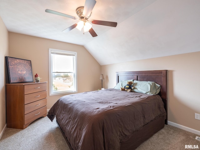 bedroom with light carpet, vaulted ceiling, and ceiling fan