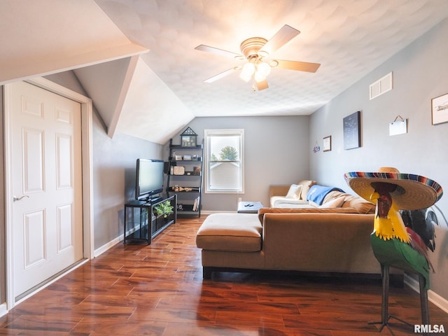 living room featuring dark hardwood / wood-style flooring, ceiling fan, and lofted ceiling