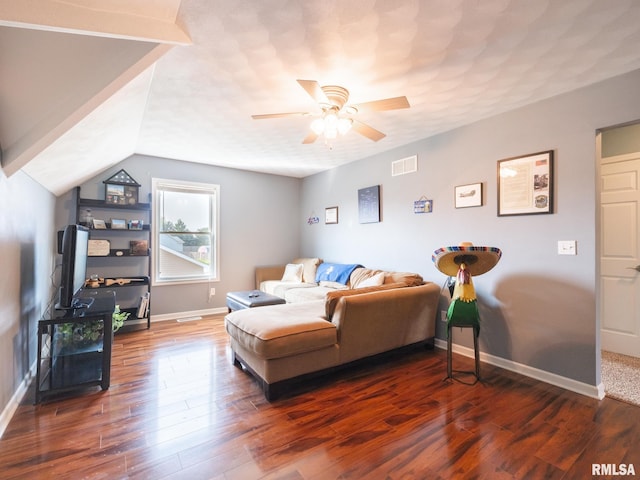 living room with ceiling fan, vaulted ceiling, and dark hardwood / wood-style flooring