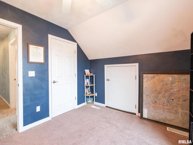 additional living space featuring lofted ceiling and light colored carpet