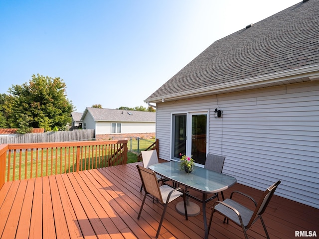 wooden terrace featuring a yard