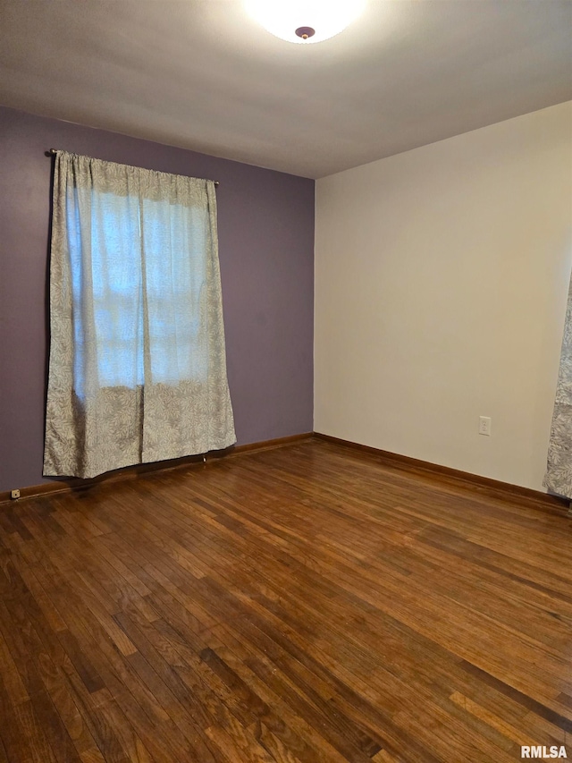 unfurnished room with wood-type flooring