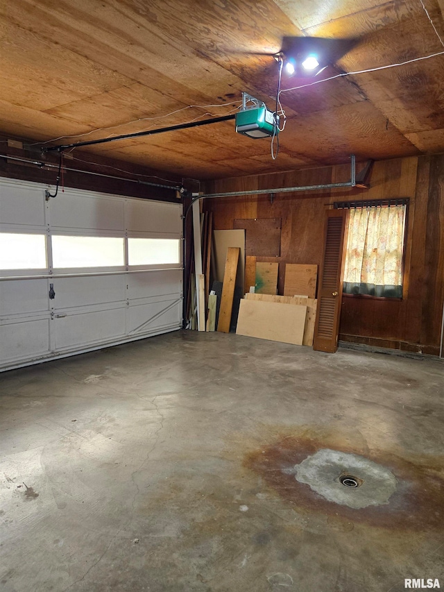 garage with wood walls, a garage door opener, and wooden ceiling