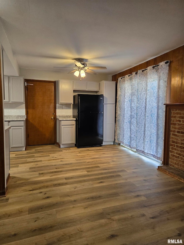 unfurnished living room featuring light wood-type flooring and ceiling fan