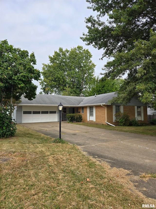 single story home with a garage and a front yard