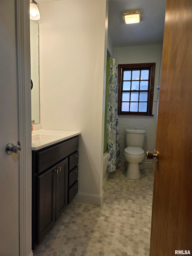 full bathroom with vanity, toilet, and shower / bath combo with shower curtain