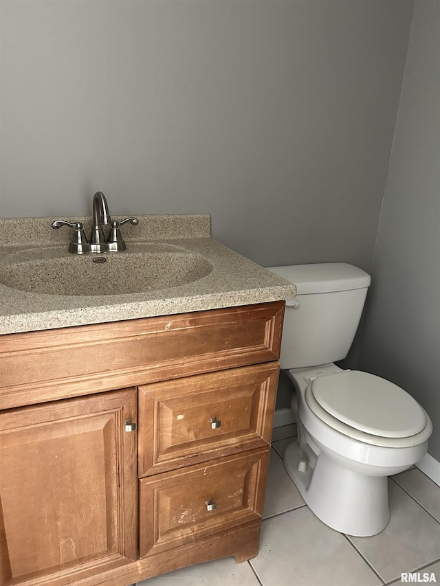 bathroom with tile patterned floors, vanity, and toilet