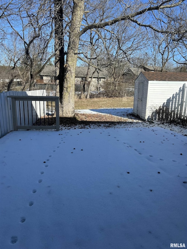 snowy yard with a storage unit