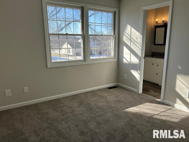 empty room featuring dark colored carpet