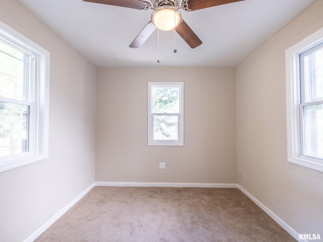 carpeted spare room with ceiling fan