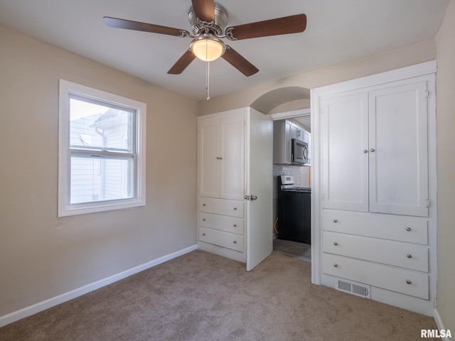 unfurnished bedroom featuring ceiling fan and light colored carpet