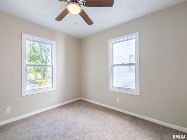 carpeted empty room featuring ceiling fan