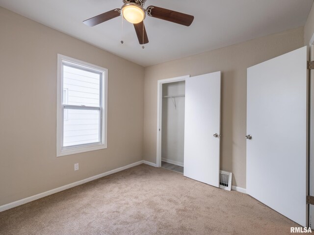 unfurnished bedroom with ceiling fan, a closet, and light carpet